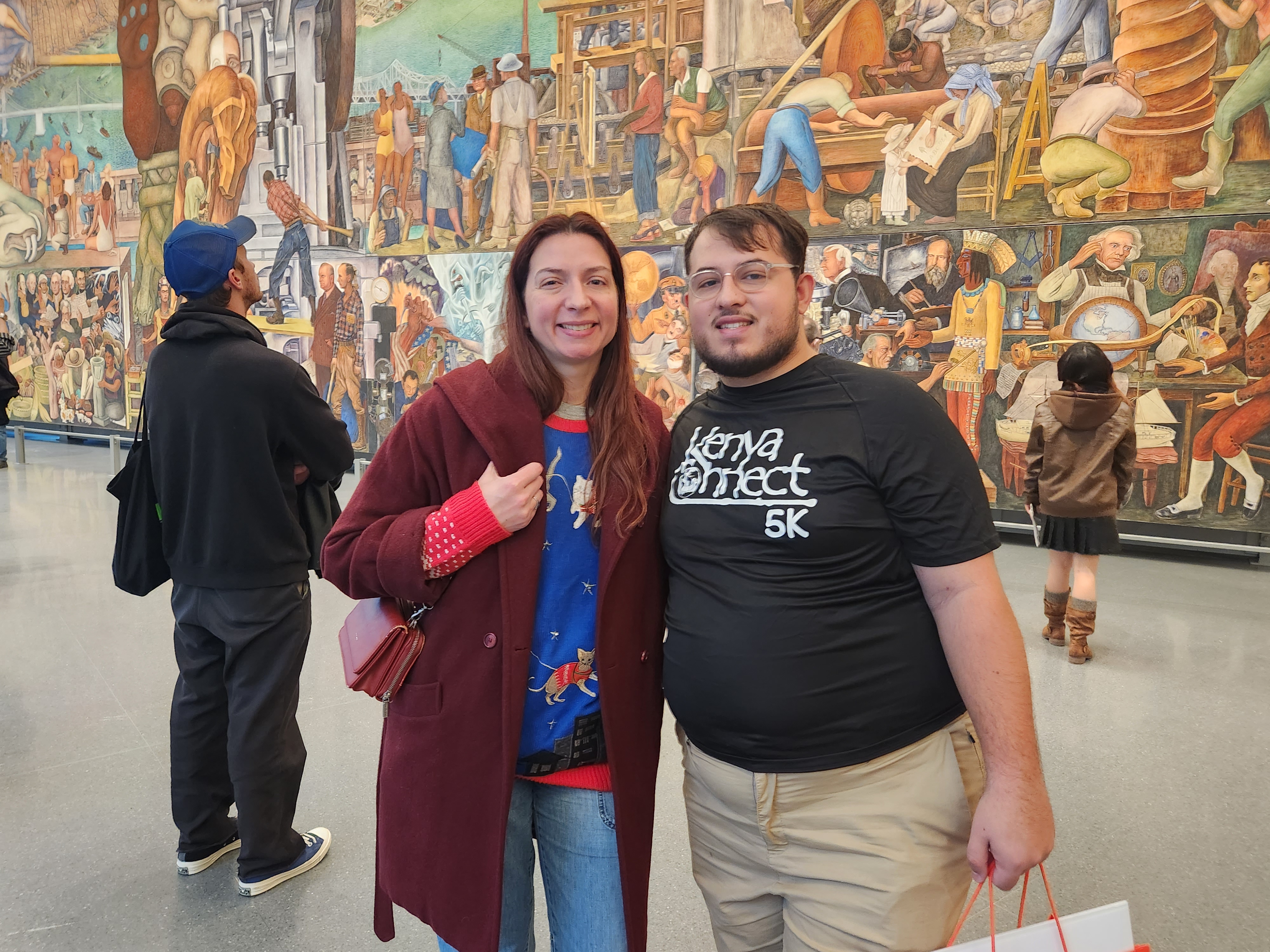 Alex and Jessica in front of the Pan American Unity mural in San Francisco