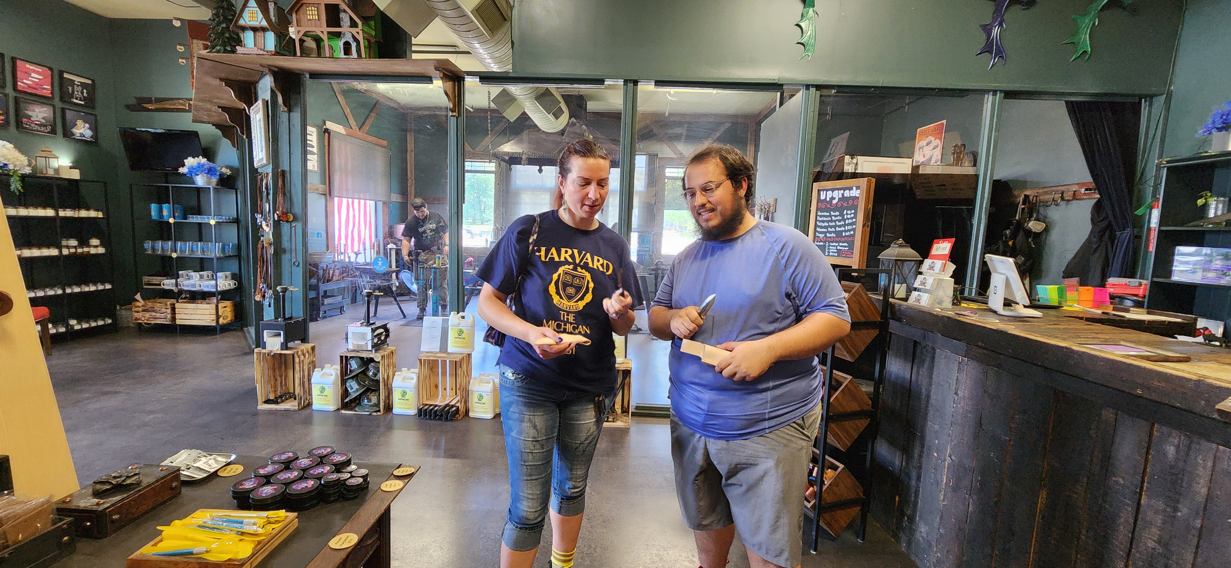 Alex and Jessica holding the knives they forged themselves at a blacksmith shop
